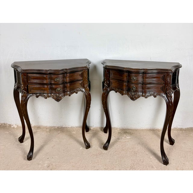 Elegant pair of French Louis XV style nightstands, featuring graceful bombe fronts, finely carved details, and beautifully...