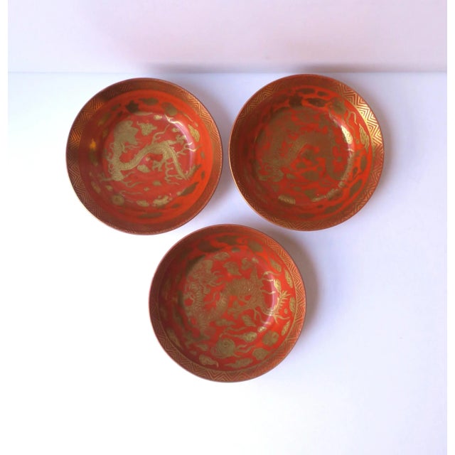 A set of three (3) Japanese porcelain gold and red finger or nut bowls with dragon design, circa mid-20th century, Japan....