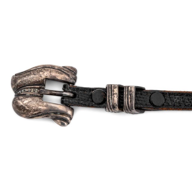 B. Kieselstein Cord Sterling Silver Belt Buckle, 1981, having sterling belt loops and end tip with black leather strap,...