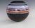 Bulbous shape matte black vase with multi colored bands in gloss finish . Reminiscent Of Marilyn Kay Austin work for...