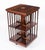 This is an antique flame mahogany revolving bookcase, circa 1980 in date. It is made of flame mahogany with decoration to...