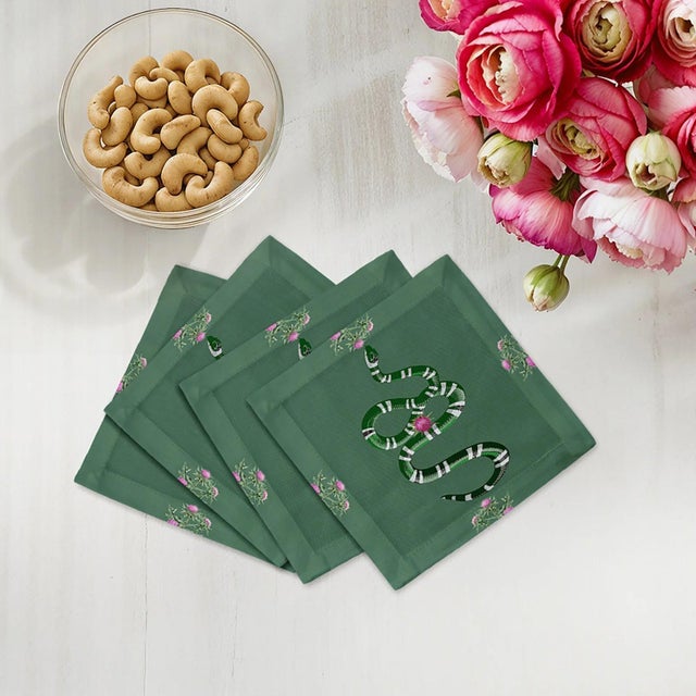 Thistle And Snake Cocktail Napkins intertwine thistle floral patterns with bold serpent motifs, creating a striking mix of...