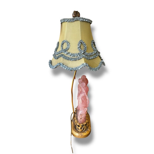 Whimsical and highly decorative vintage table lamp featuring an intricately carved rose quartz figural base mounted on an...
