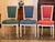 Six painted side chairs with upholstered seats and backs, currently covered in three different colors — two each in red,...