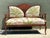 This vintage carved wood settee beautifully combines refined craftsmanship with richly decorative textile artistry. The...