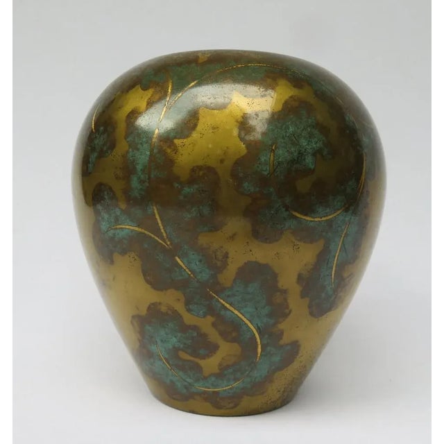 A flower vase, referred to under the stand with the tower brand WMF Ikora, from the time of Art Deco, the 1920s. The vase...