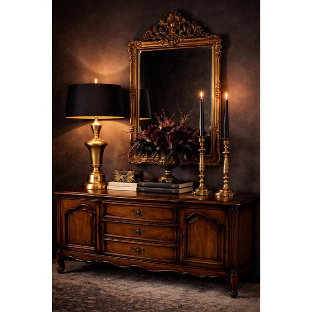 A sculptural vintage brass lamp reimagined in a warm sunlit finish, paired with a dramatic black drum shade with gold...