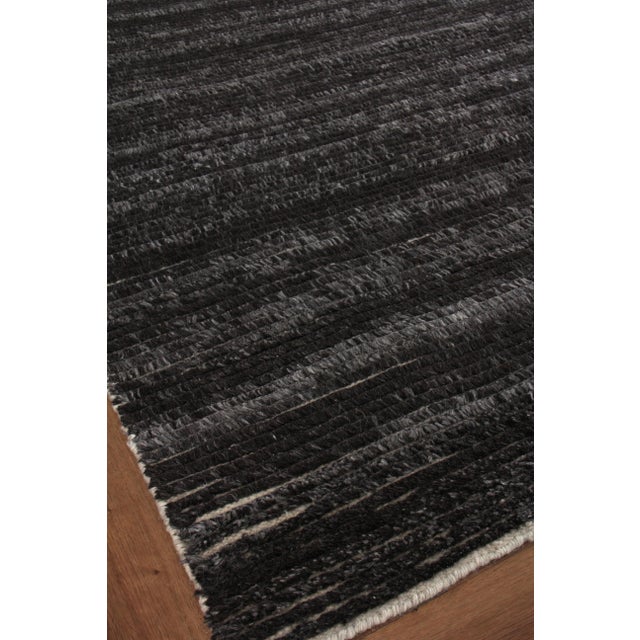 The Kaza rug is styled with linear tall yarn woven in distinctive rows. The natural, wool tones, lending slight variations...