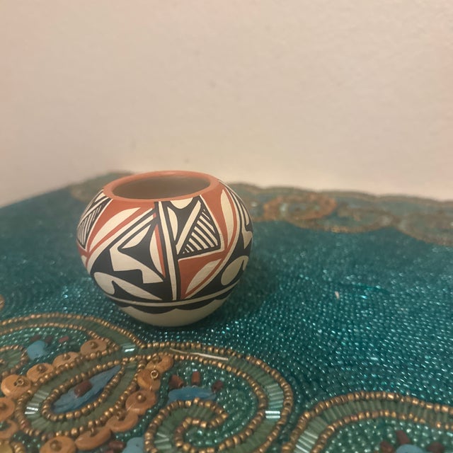 An exquisite mid-to-late 20th-century miniature polychrome pottery jar crafted in the tradition of the Acoma Pueblo (Sky...