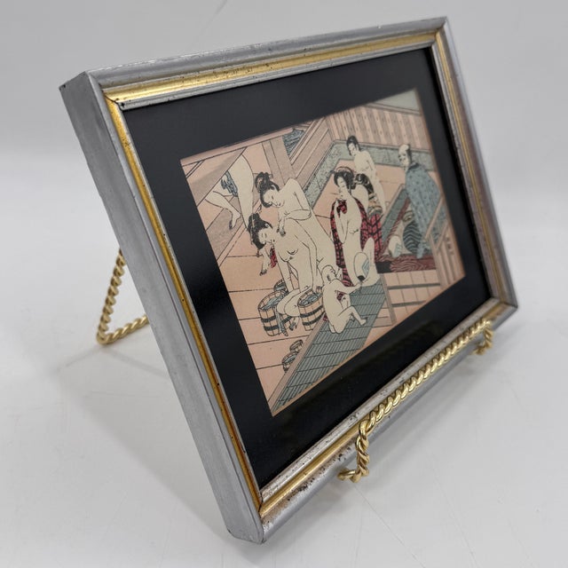 Vintage Japanese woodblock-style print after Torii Kiyonaga, depicting women inside a traditional communal bathhouse....