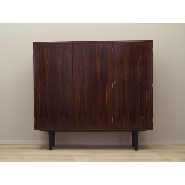 The bookcase was made in the 1960s, designed by Danish design icon Kai Winding. The structure is covered with rosewood...
