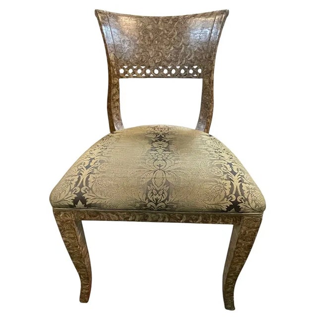 Elegant carved dining set featuring a round glass-top table and four matching upholstered chairs. The table base and chair...