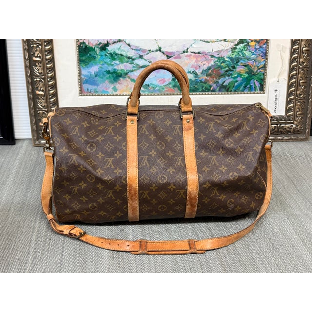 Design Plus Gallery presents a Boston Keepall Bandoulière from Louis Vuitton. This stylish duffel is crafted of signature...