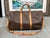 Design Plus Gallery presents a Boston Keepall Bandoulière from Louis Vuitton. This stylish duffel is crafted of signature...