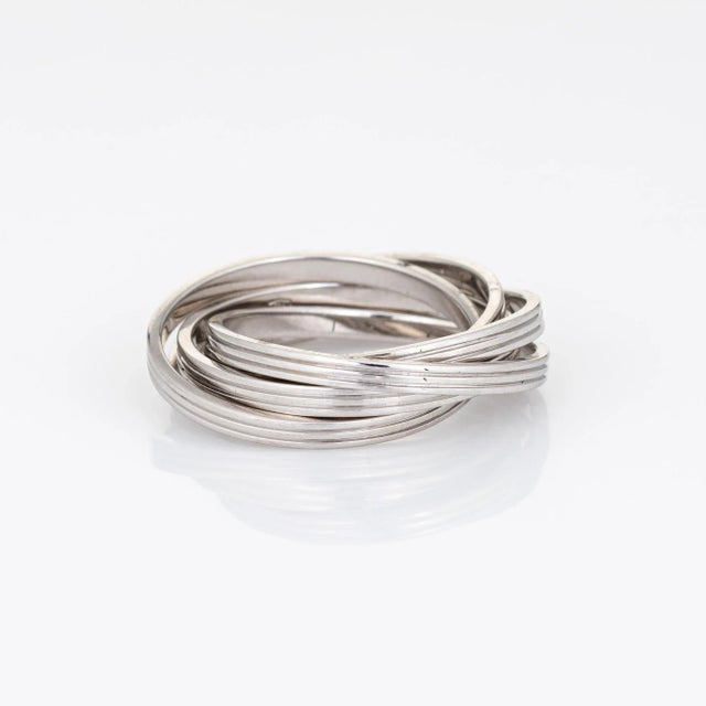 Estate Gucci rolling ring crafted in 18k white gold. The Gucci ring features 5 interlocking bands crafted in 18k white...