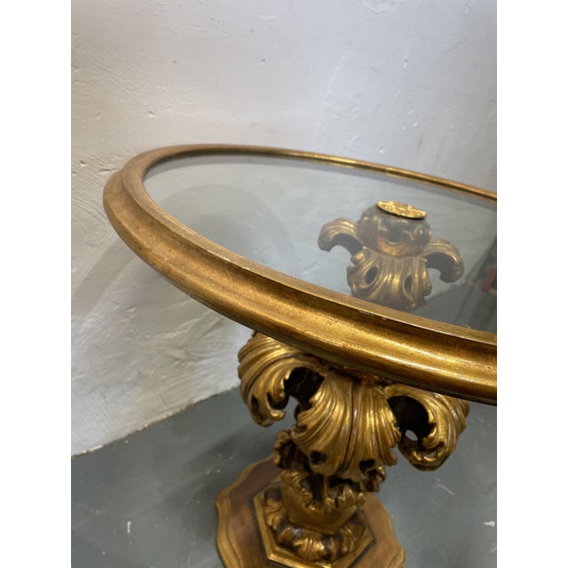 The side table has a wooden base with a glass top, dating from the 1960s and made in Italy. It's in lovely used condition...