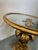 The side table has a wooden base with a glass top, dating from the 1960s and made in Italy. It's in lovely used condition...