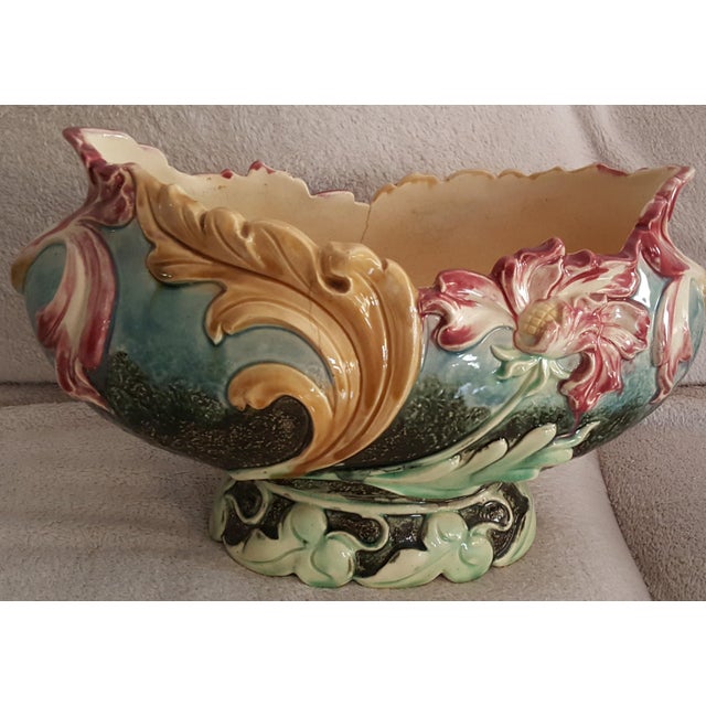 This is A Majolica Centre Bowl, circa 1910. Of oval baluster form on a low foot, moulded in relief with large stylised...
