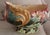 This is A Majolica Centre Bowl, circa 1910. Of oval baluster form on a low foot, moulded in relief with large stylised...