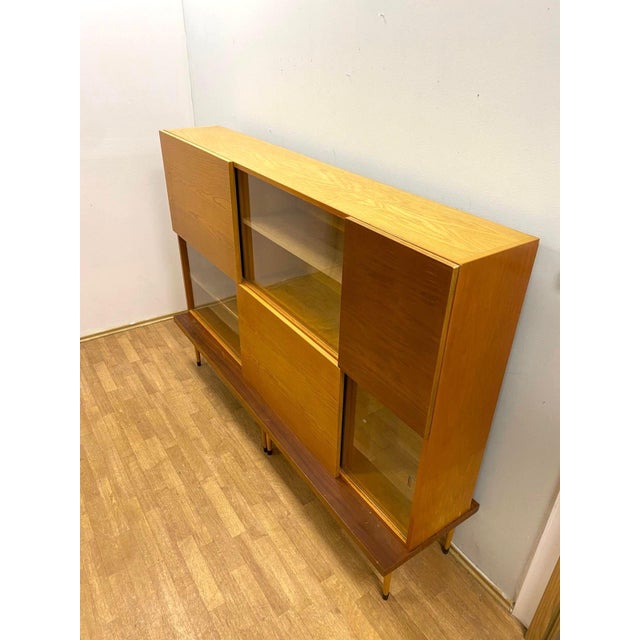 A stylish Brussels-era retro cabinet / bookcase produced in Czechoslovakia during the 1960s. This elegant Mid-Century...
