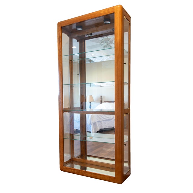This beautiful matching pair of solid oak curio/display cabinets offers a cohesive, high-end look for showcasing your...
