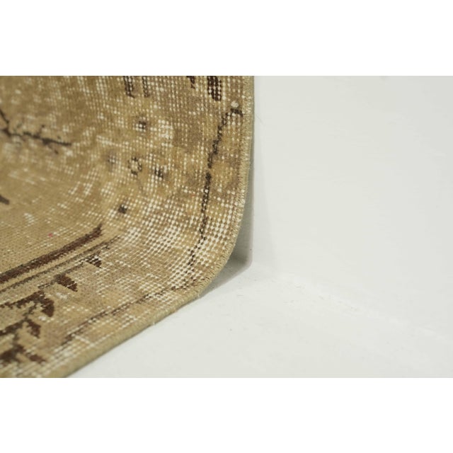 This vintage hand-knotted area rug is a semi-antique vintage area rug. The '70s Eastern Anatolian region's unique rug is...
