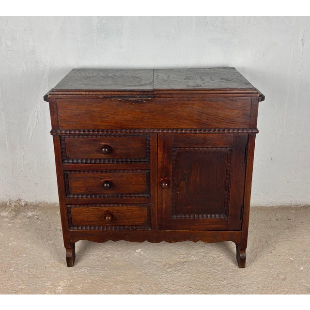 Early 20th century Spanish sewing cabinet crafted in solid oak with a warm rustic patina and highly functional interior....
