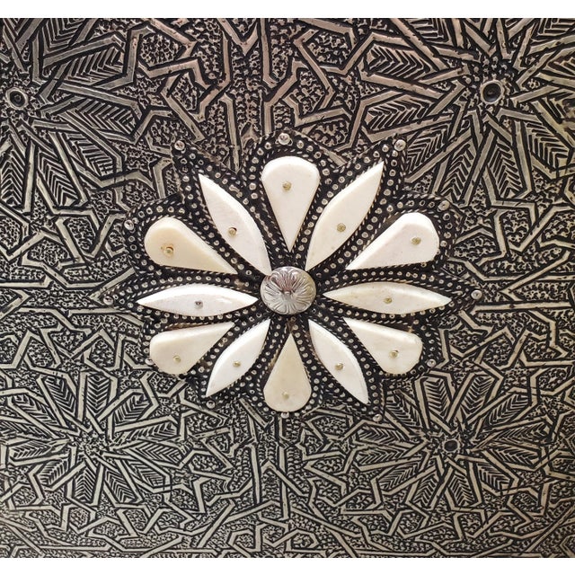 Add a touch of Moroccan artistry to your space with this handcrafted metal accent table. Its petite size, intricate...