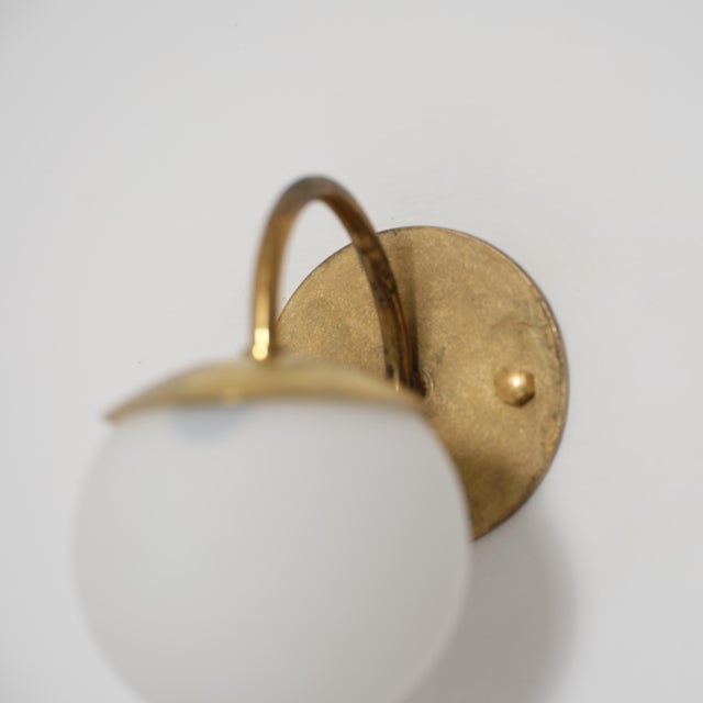 Pair of italian wall sconces dating from the 1950s, designed with a simple and well-balanced composition typical of mid-...