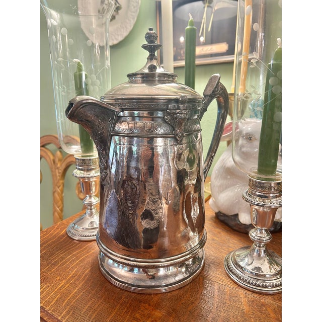 This is a late-19th-century silver-plated ice water pitcher by Reed & Barton of Taunton, Massachusetts, dating to circa...