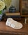 A striking Grand Tour-style plaster sculpture depicting a sandaled foot inspired by classical Greek and Roman antiquity....