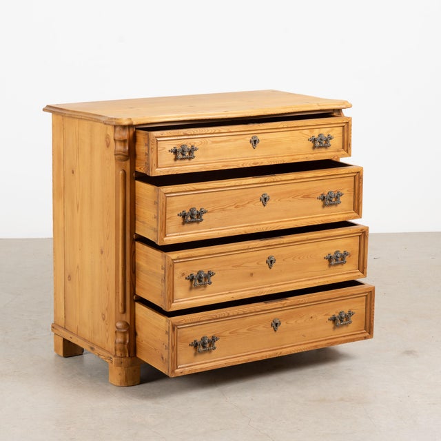 19th century Danish chest of four drawers, crafted in pine with a warm wax finish that highlights the natural color and...
