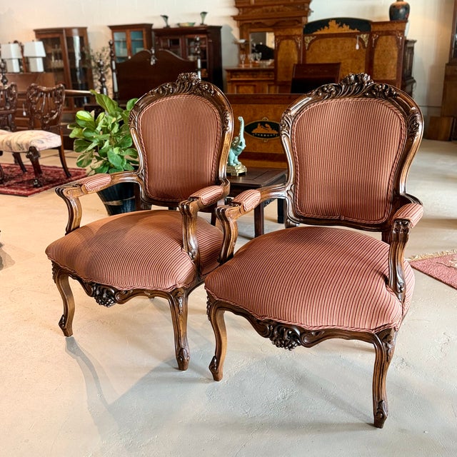 Pair of vintage walnut armchairs in the Louis XV-style with professionally upholstered striped seats and backs in a muted...
