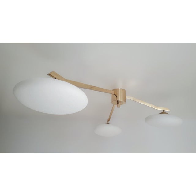 Italian flush mount with three matte white Murano glass shades tiered at different heights, mounted on solid brass frame...