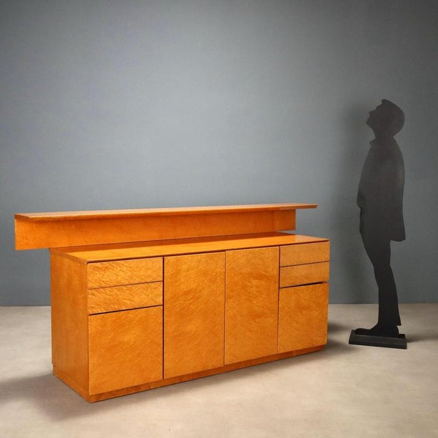 1980s burl wood sideboard with open hutch, featuring a functional and linear design typical of the era. Made of burl wood...