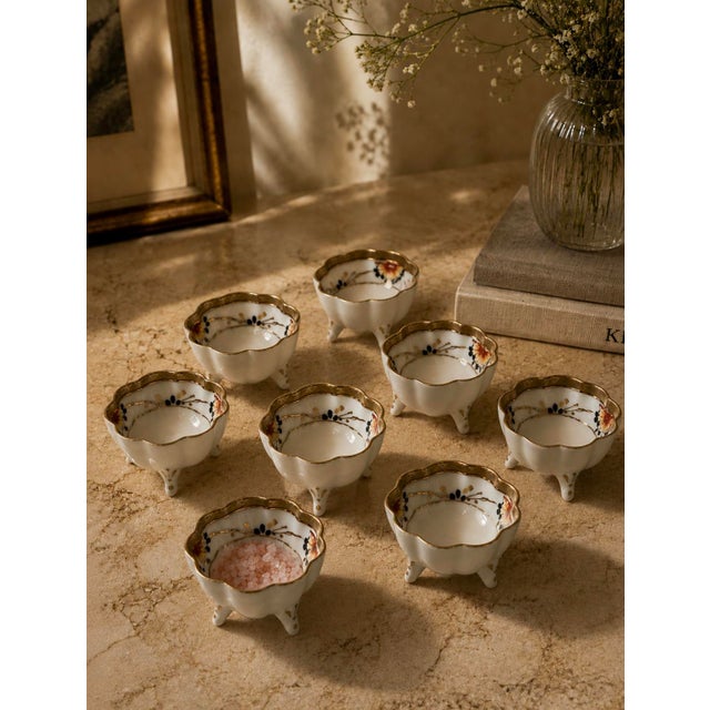 A complete and charming set of eight antique Japanese open salt cellars, each marked “Hand Painted NIPPON” — placing their...