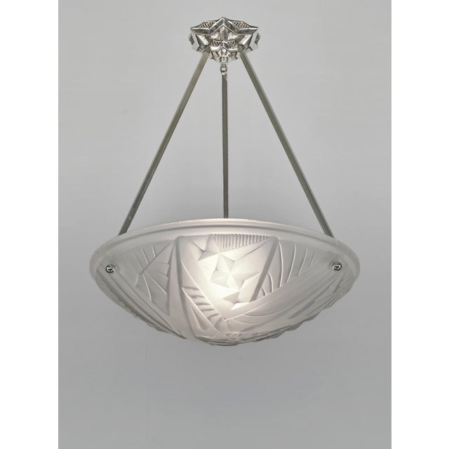 NOVERDY & MAYNADIER A French 1930s art deco pendant light in nickel plated solid brass holding a bowl in clear frosted...