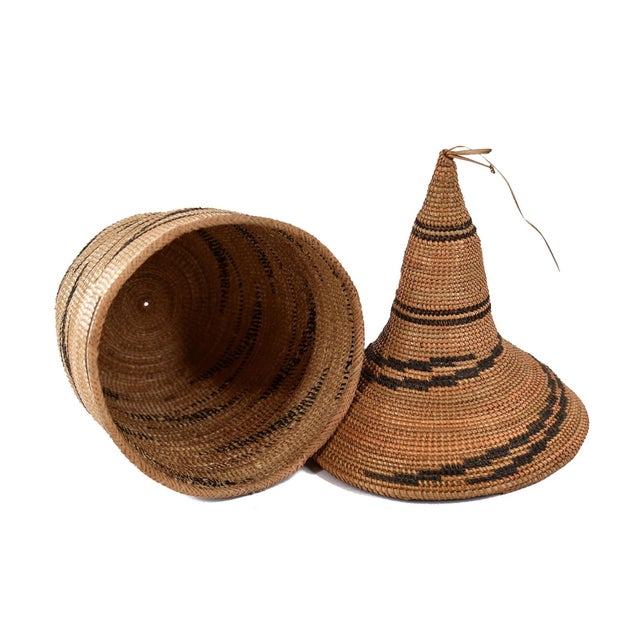 The Tutsi Tight Weave Basket with Lid from Rwanda epitomizes the artistry and tradition of the Tutsi community's weaving...
