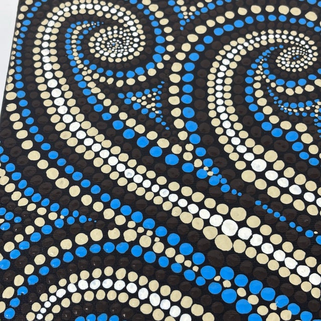 Original dot mandala painting features intricate swirling patterns in a palette of blue, cream, and brown. This...