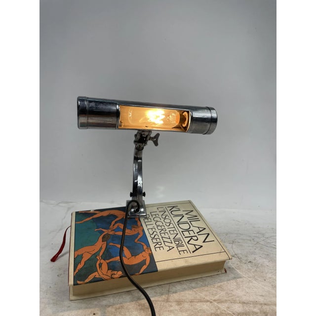 A beautiful antique music stand lamp that used to be mounted on pianos, with an adjustable pivot, made of steel. An...
