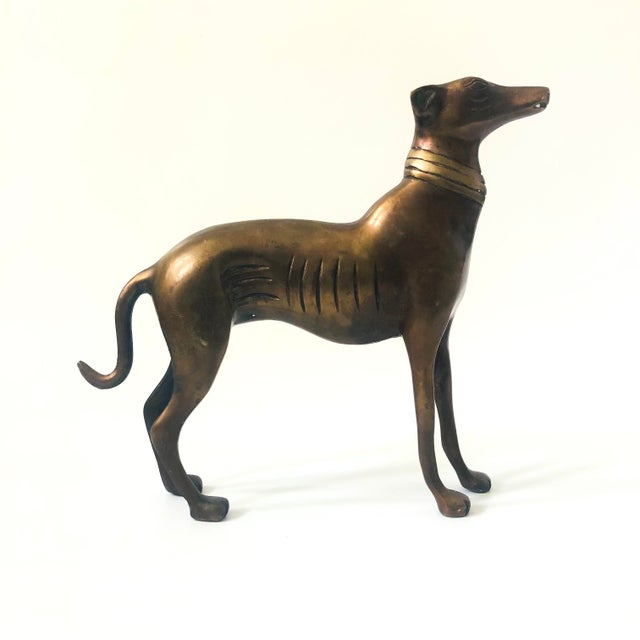 A vintage mid century bronze greyhound statue. Great mid century stylized design, dark coloring to the bronze.