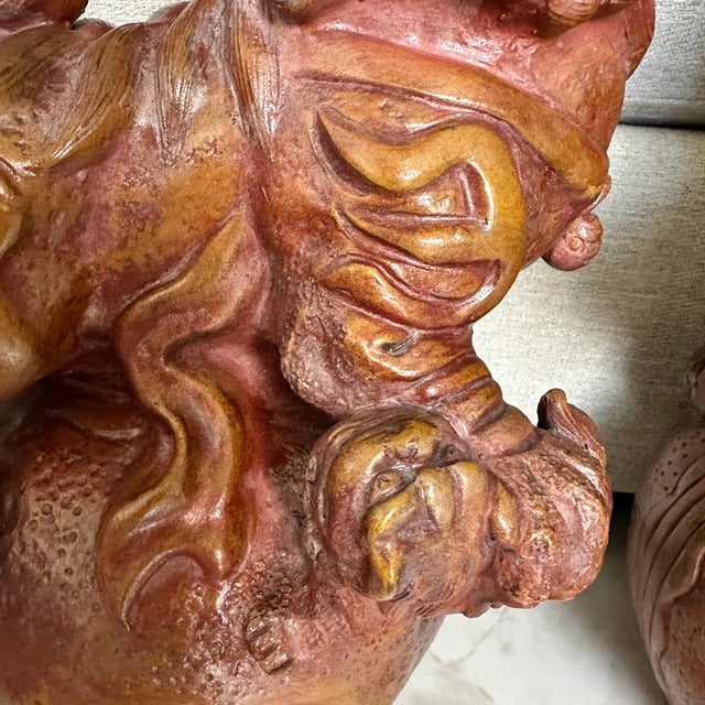 Impressive pair of large terracotta Chinese Foo Dogs / Guardian Lions, each measuring approximately 19 inches tall. The...