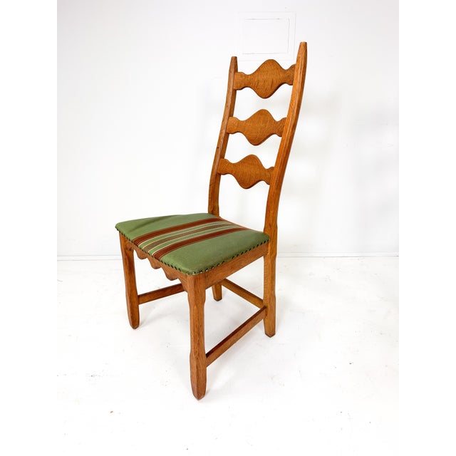 Set of four dining chairs by Henning Kjaernulf for Nyrup Mobelfabrik. Sculpted solid Oak carved frames have a warm rustic...