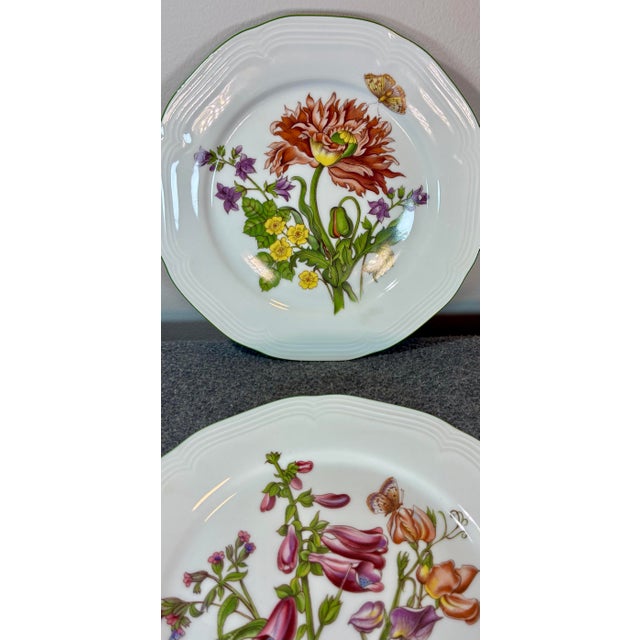 Features a detailed floral bouquet with a butterfly and a green rim.