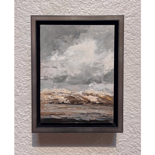 The painting captures a dramatic landscape just before a storm, with swirling gray clouds dominating the sky and hinting...