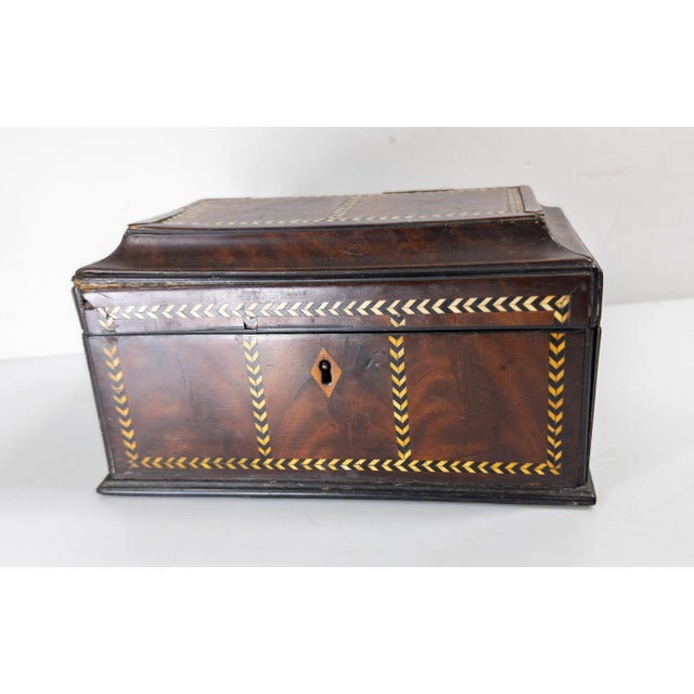 We are selling this gorgeous Mahogany veneer English Regency tea caddy. This caddy has elegant Sarcophagus form with...