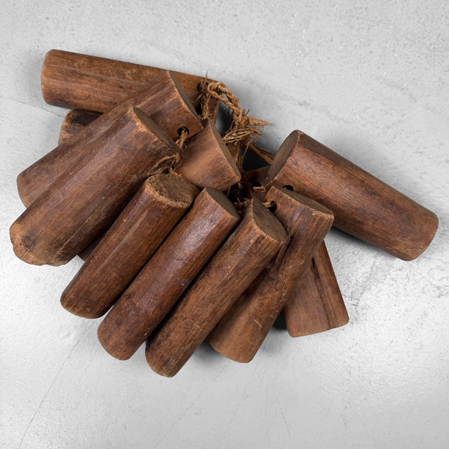 Characterful set of eleven wooden loom weights from Japan, originally part of a traditional handloom. The weights are...