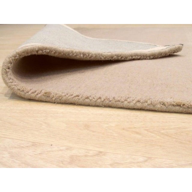 This ivory beige cream white wool rug features a traditional hand knotted pile weave. As an Agra style rug, it combines...