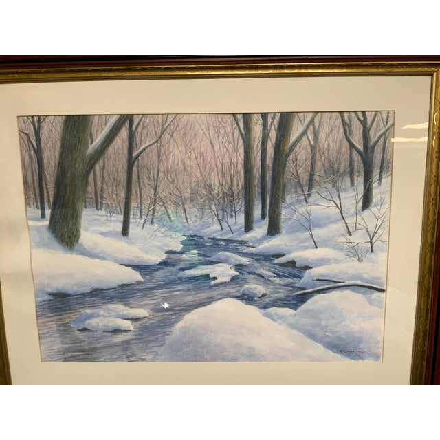 Watercolor snowy landscape with brook, signed by the Connecticut artist Charles McCaughtry, dated 1986. 20” x 29” image...