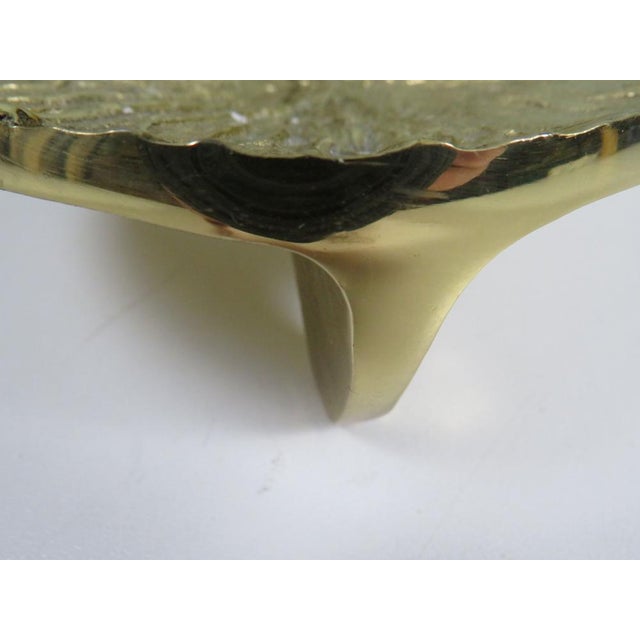 A sculptural mid-century candle holder in solid brass, dating from the 1960s–70s. The design is defined by its low...